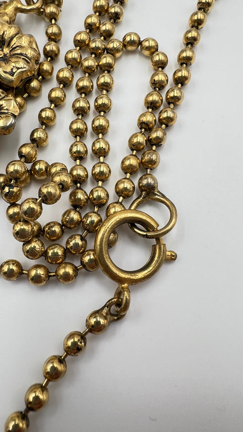 Collana dorata con pendente floreale vintage