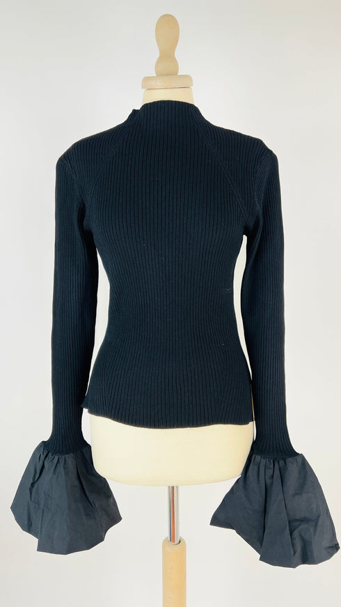 Top a coste con maxi polsini