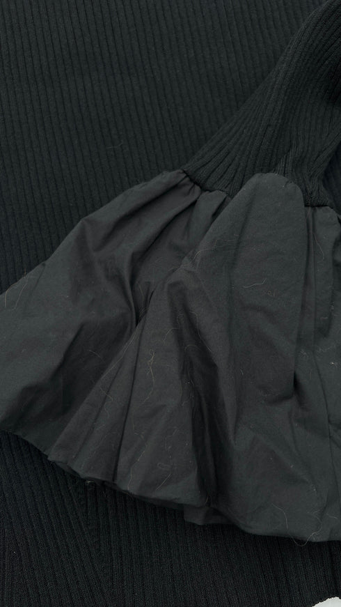 Top a coste con maxi polsini