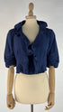 Bolero blu con cartellino
