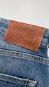 Jeans slim con cartellino