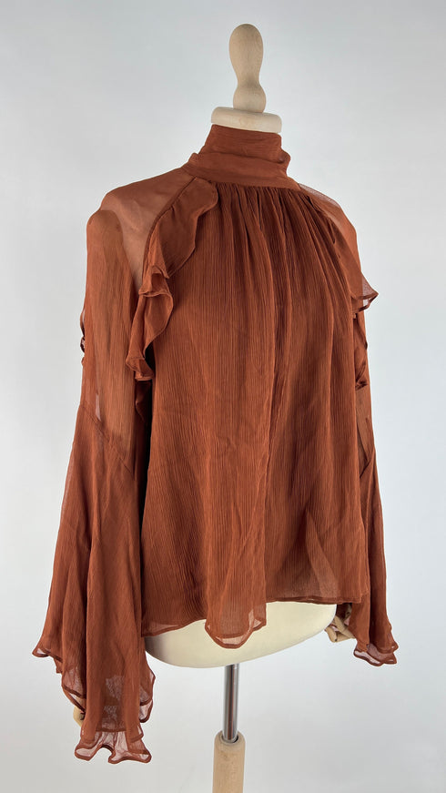 Blusa con fiocco e cartellino