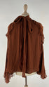 Blusa con fiocco e cartellino