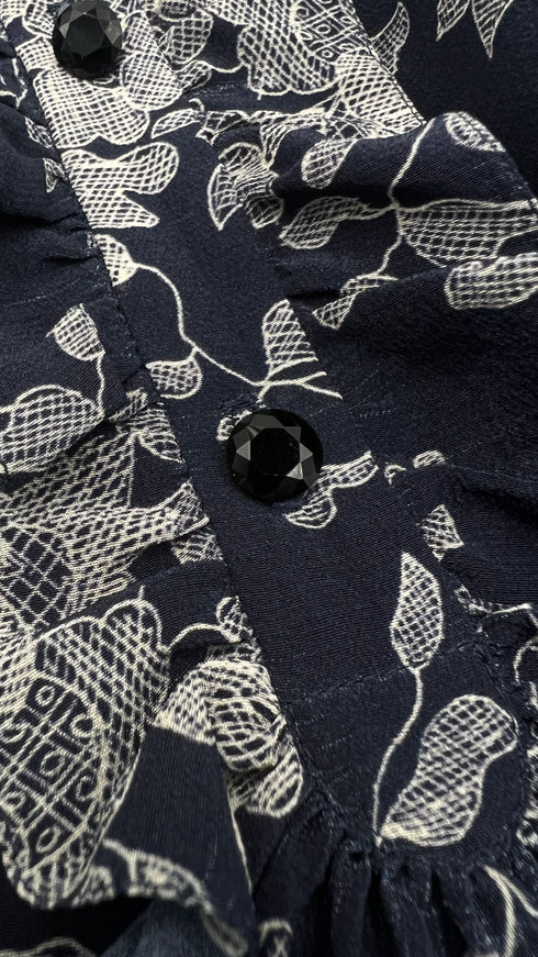 Camicia floreale con volant e pieghe