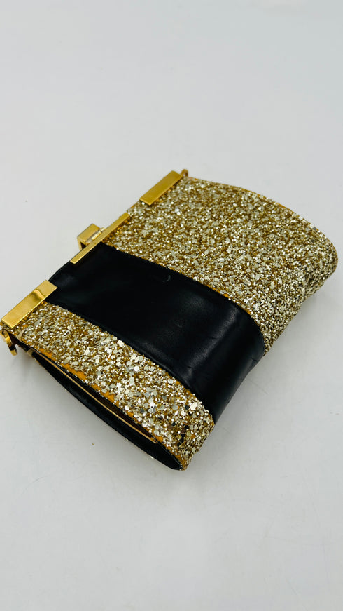 Clutch glitterata dorata con inserto in pelle