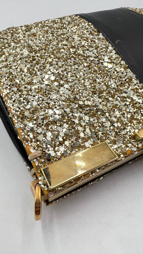 Clutch glitterata dorata con inserto in pelle