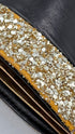 Clutch glitterata dorata con inserto in pelle