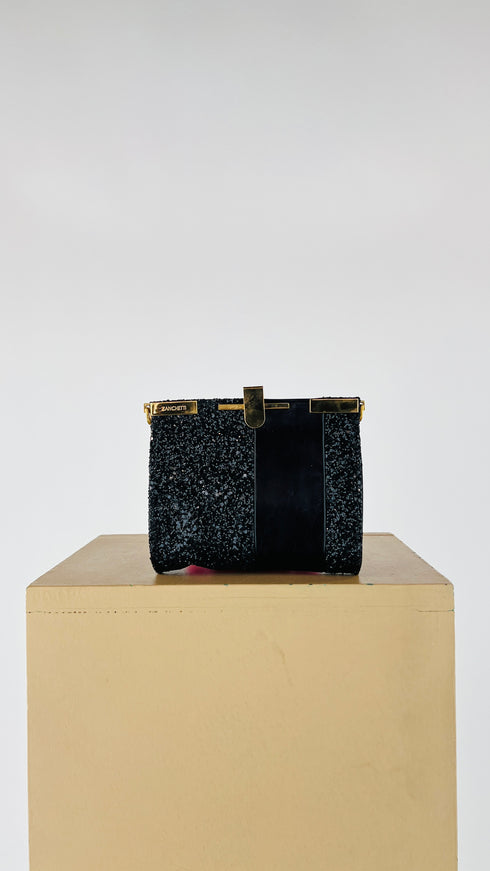 Clutch glitterata con inserto in pelle