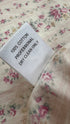 Top floreale con cartellino